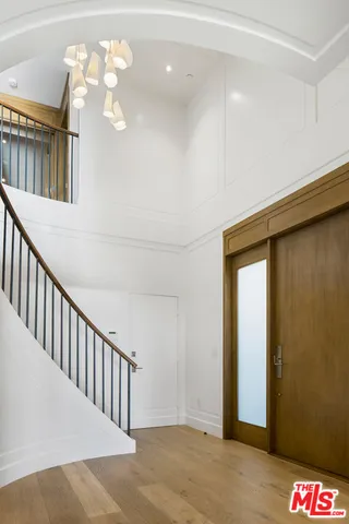 a view of staircase with railing and white walls