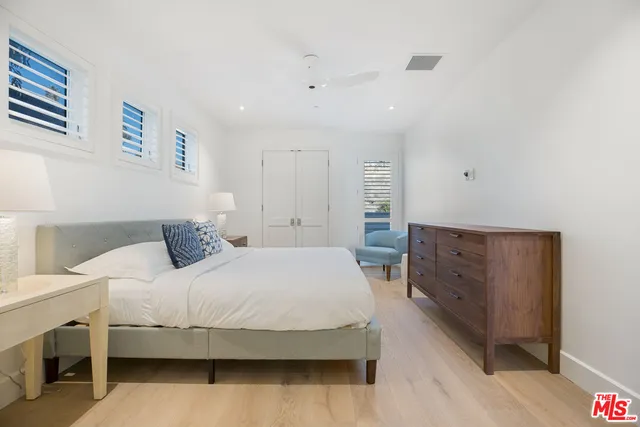 a spacious bedroom with a bed and a couch