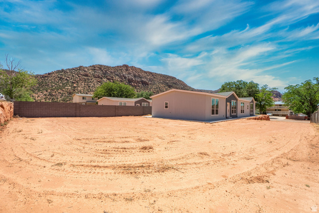 464 Jessop Avenue Hildale, UT 84784 - Photo 41 of 73 Expansive lot featuring a newly constructed residence with a gray facade, dark trim, and multiple windows