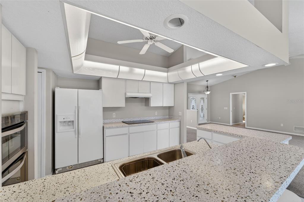 4541 Blueridge Street North Port, FL 34287 - Photo 13 of 52 a kitchen with stainless steel appliances kitchen island granite countertop a refrigerator and a sink