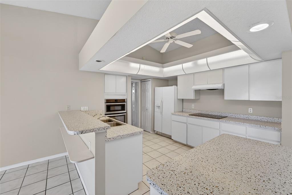 4541 Blueridge Street North Port, FL 34287 - Photo 14 of 52 a kitchen with granite countertop a stove a sink and a refrigerator