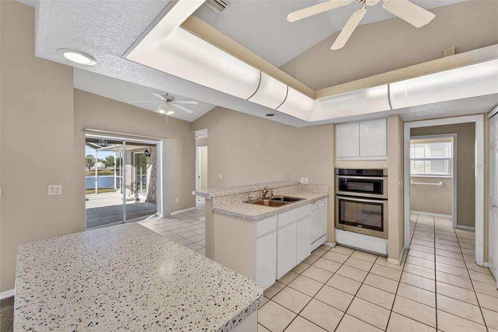 4541 Blueridge Street North Port, FL 34287 - Photo 15 of 52 a kitchen with stainless steel appliances kitchen island granite countertop a stove and a sink