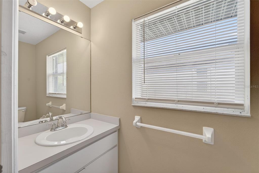 4541 Blueridge Street North Port, FL 34287 - Photo 16 of 52 a bathroom with a sink a vanity and a mirror