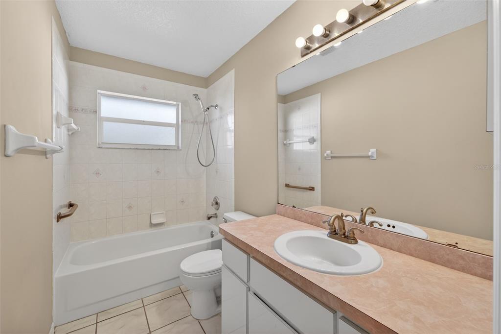 4541 Blueridge Street North Port, FL 34287 - Photo 20 of 52 a bathroom with a granite countertop sink a toilet and shower