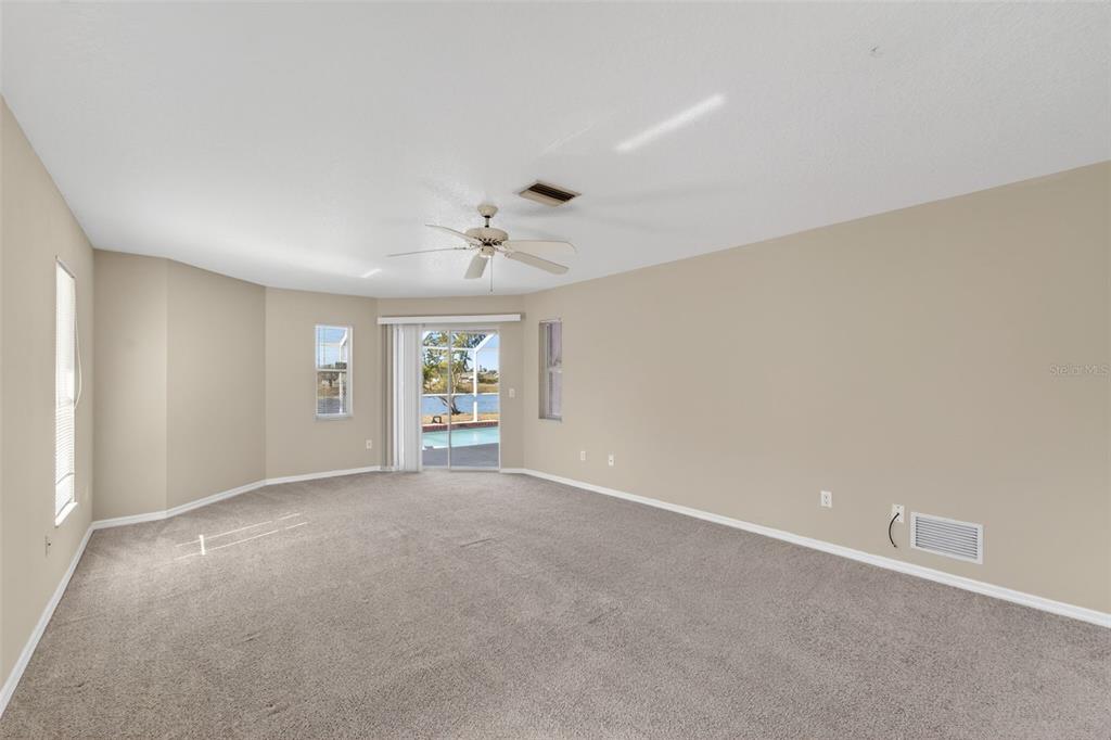 4541 Blueridge Street North Port, FL 34287 - Photo 27 of 52 a view of a big room with windows and chandelier fan