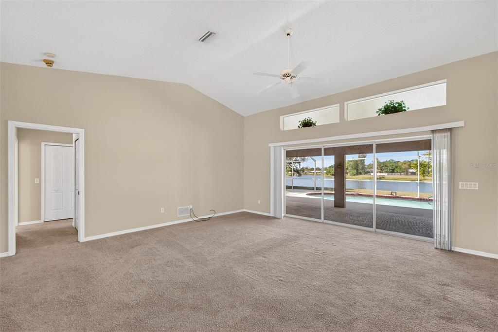 4541 Blueridge Street North Port, FL 34287 - Photo 7 of 52 an empty room with wooden floor and windows