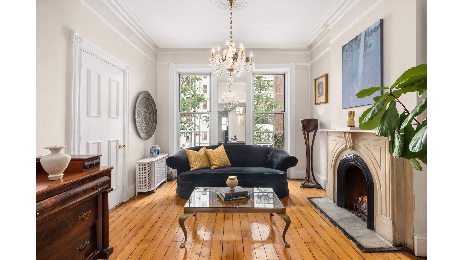 412 East 89th Street Manhattan, NY 10128 - Photo 6 of 25 a living room with furniture a chandelier and a fireplace