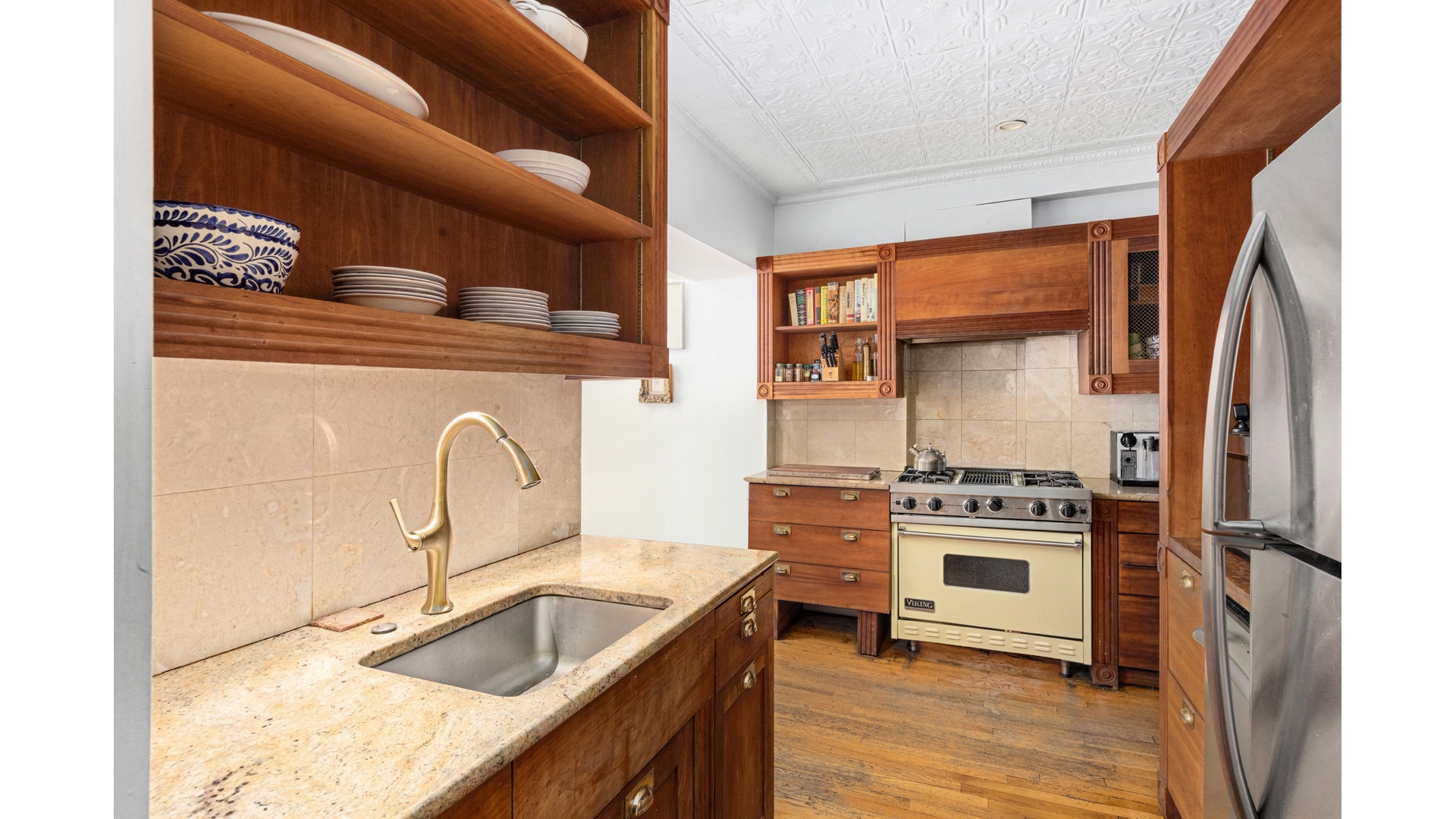 412 East 89th Street Manhattan, NY 10128 - Photo 9 of 25 a kitchen with stainless steel appliances granite countertop a sink stove and refrigerator