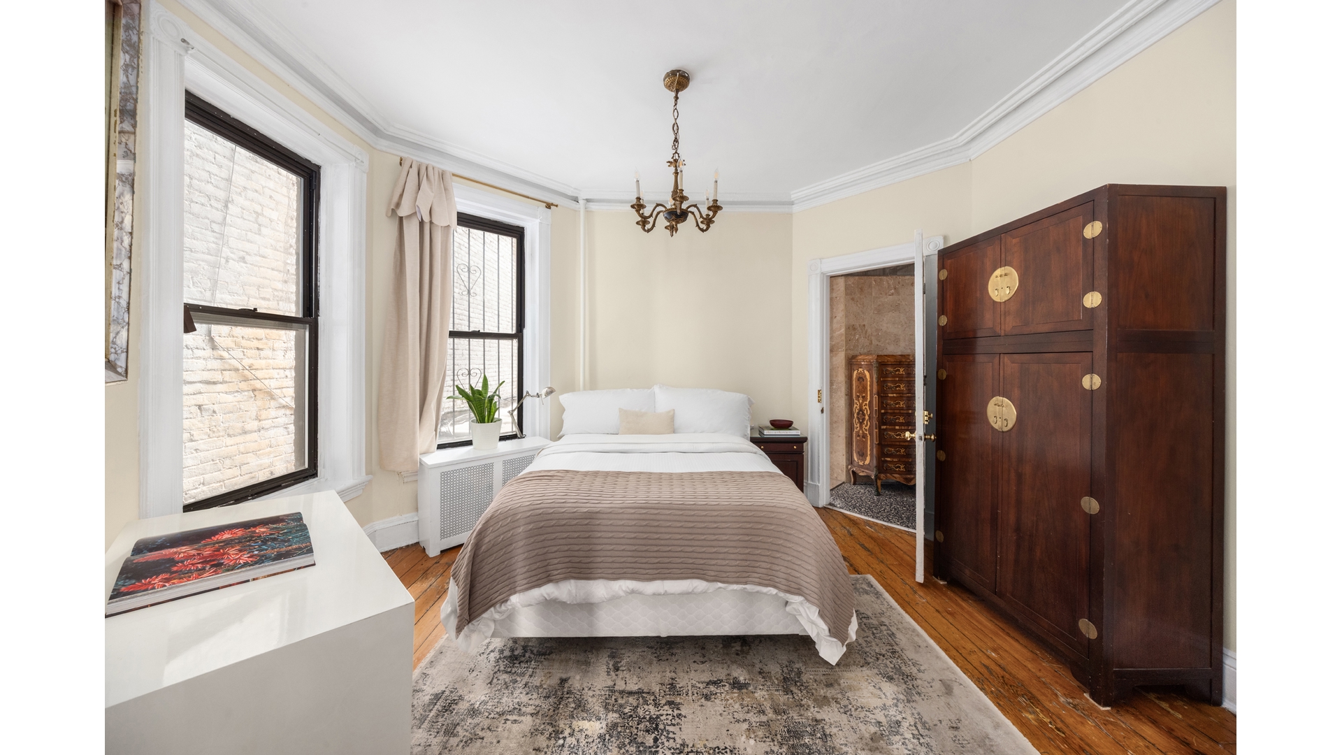 412 East 89th Street Manhattan, NY 10128 - Photo 12 of 25 a bedroom with a bed dresser and a window