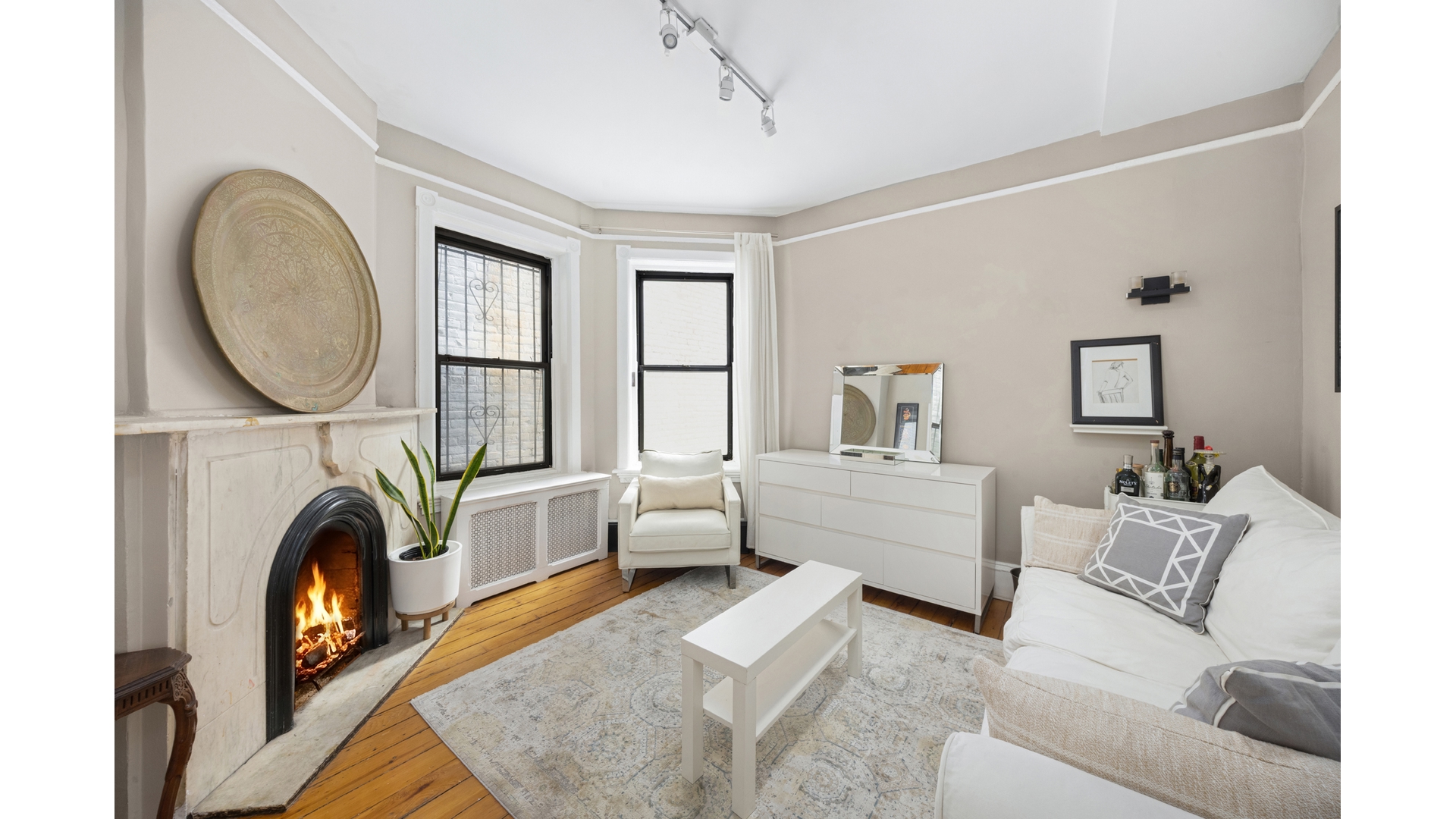 412 East 89th Street Manhattan, NY 10128 - Photo 17 of 25 a living room with furniture and a fireplace