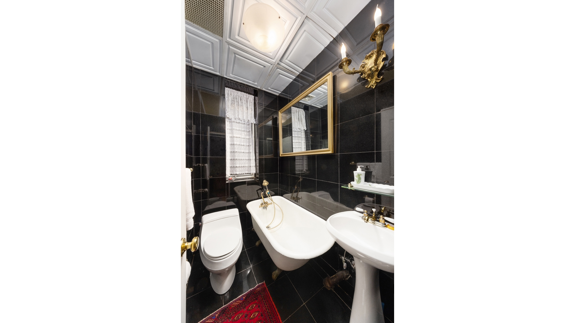 412 East 89th Street Manhattan, NY 10128 - Photo 18 of 25 a bathroom with a sink and a mirror