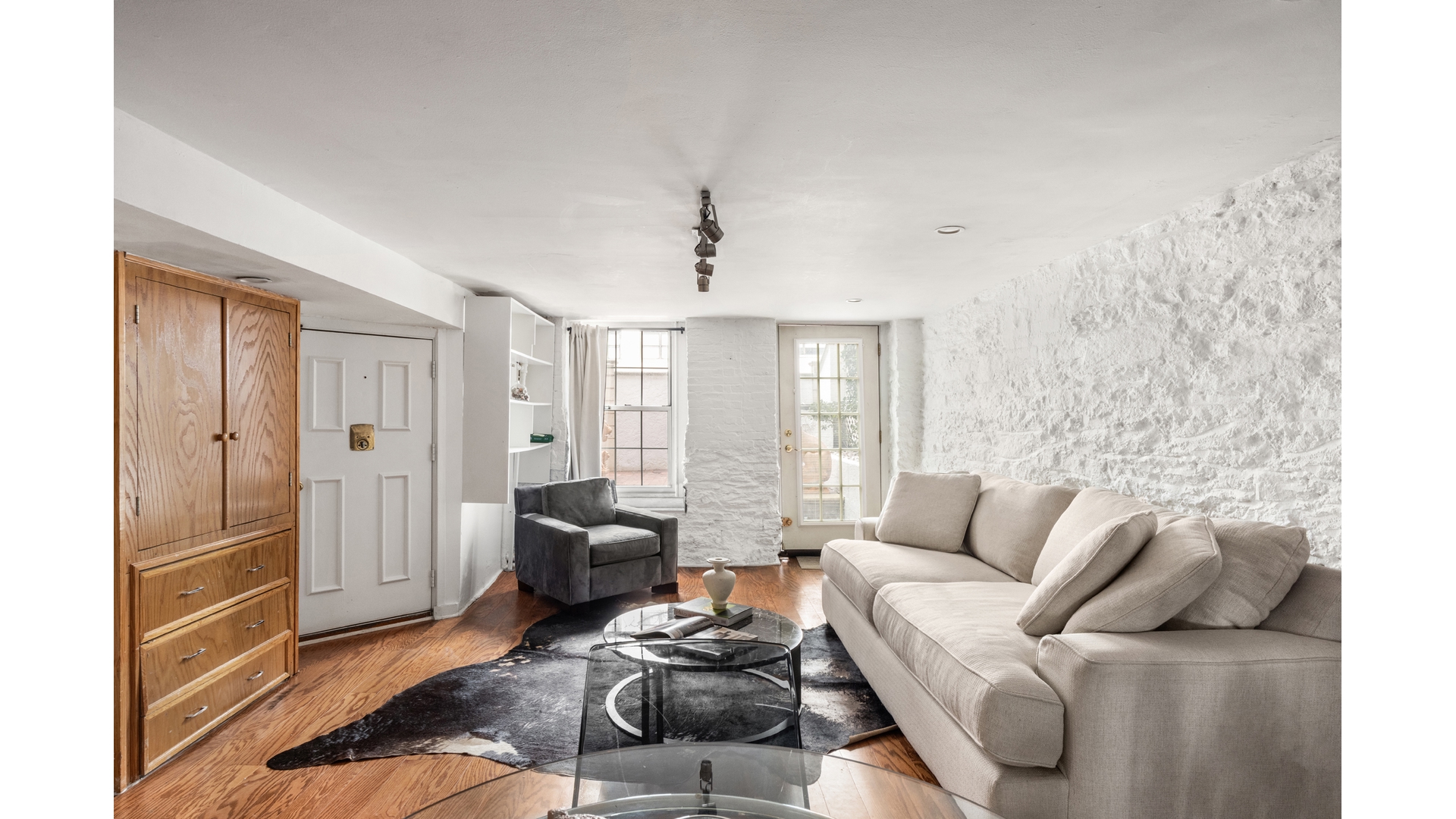 412 East 89th Street Manhattan, NY 10128 - Photo 19 of 25 a living room with furniture and a window