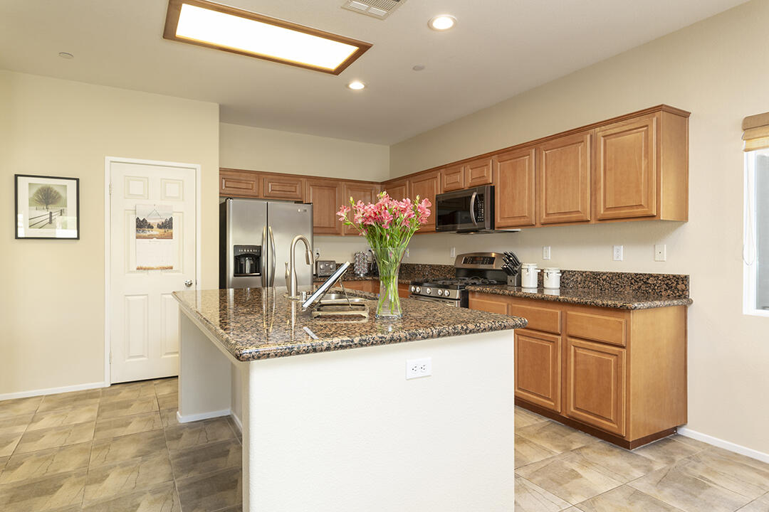 1280 Oro Ridge Palm Springs, CA 92262 - Photo 14 of 46 a kitchen with stainless steel appliances granite countertop a sink stove and refrigerator