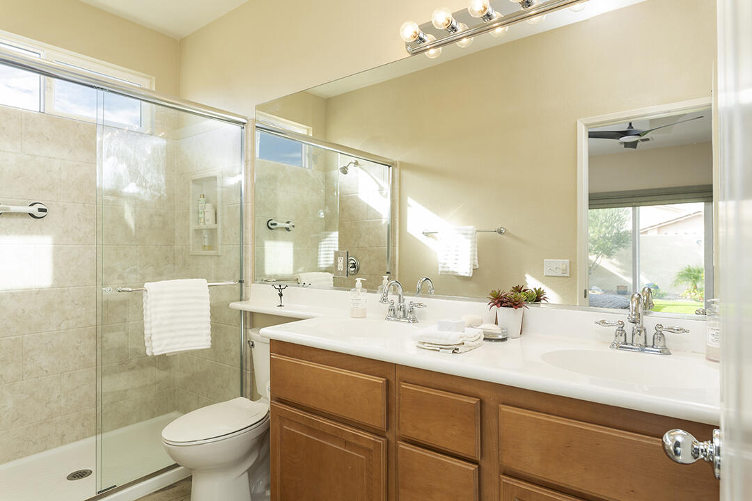 1280 Oro Ridge Palm Springs, CA 92262 - Photo 27 of 46 a bathroom with a double vanity sink toilet mirror and shower