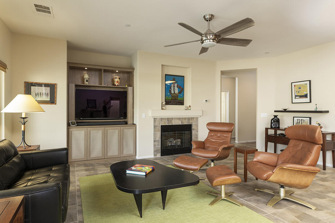 1280 Oro Ridge Palm Springs, CA 92262 - Photo 7 of 46 a living room with furniture a fireplace and a flat screen tv
