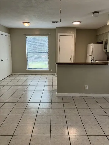 a view of kitchen with granite countertop cabinets