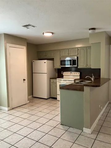 a kitchen with a refrigerator sink and microwave