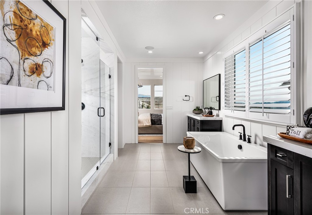 27534 Elderberry Drive Valencia, CA 91381 - Photo 13 of 17 a bathroom with a sink a mirror and a shower