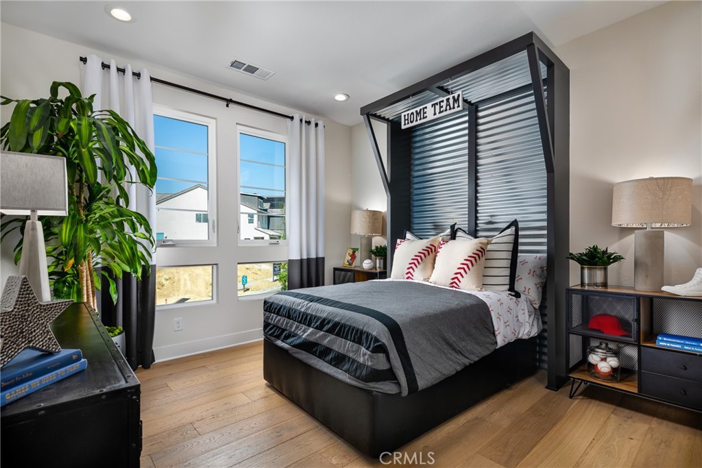 27534 Elderberry Drive Valencia, CA 91381 - Photo 14 of 17 a living room with a bed furniture and a potted plant