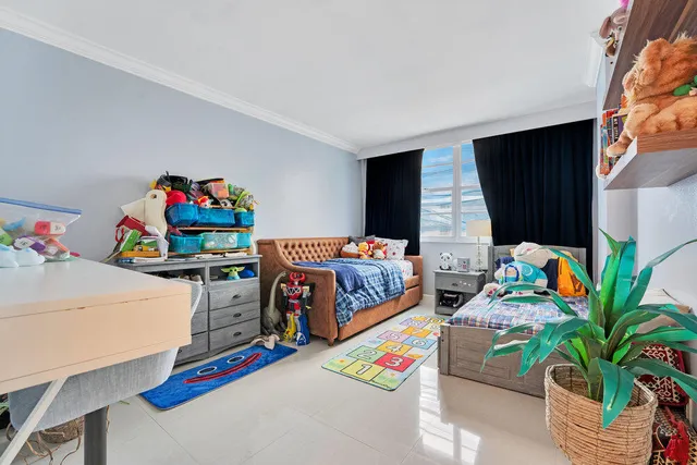 a bedroom with bed and a potted plant