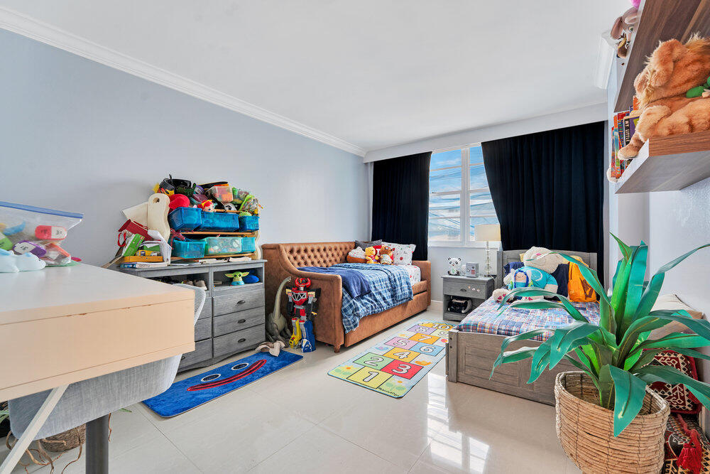 500 Bayview Drive, Unit 1521 Sunny Isles Beach, FL 33160 - Photo 12 of 31 a bedroom with bed and a potted plant