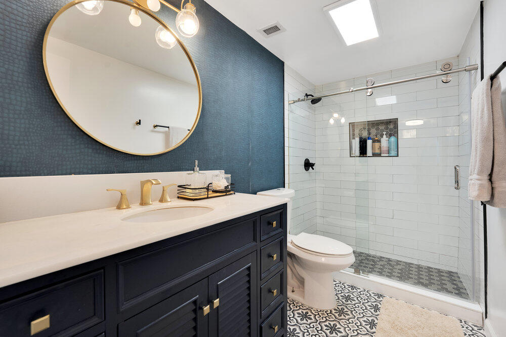 500 Bayview Drive, Unit 1521 Sunny Isles Beach, FL 33160 - Photo 13 of 31 a bathroom with a sink a toilet and a mirror