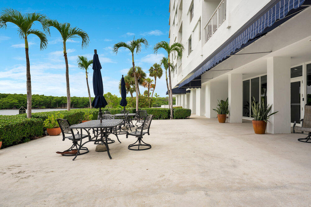 500 Bayview Drive, Unit 1521 Sunny Isles Beach, FL 33160 - Photo 22 of 31 a view of a patio with a table chairs and a patio