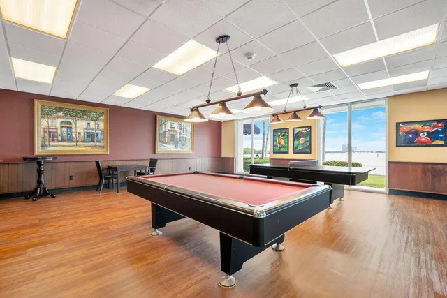 a building view with swimming pool and lawn chairs