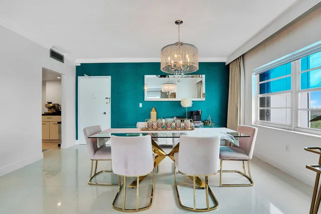 a view of a dining room with furniture a chandelier and wooden floor