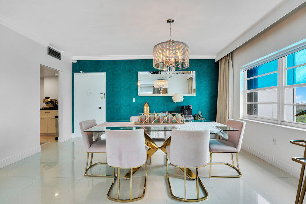 500 Bayview Drive, Unit 1521 Sunny Isles Beach, FL 33160 - Photo 6 of 31 a view of a dining room with furniture a chandelier and wooden floor