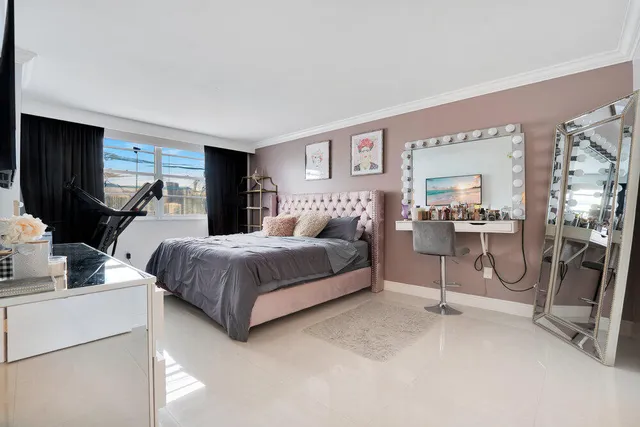 a bedroom with a bed a table and chair