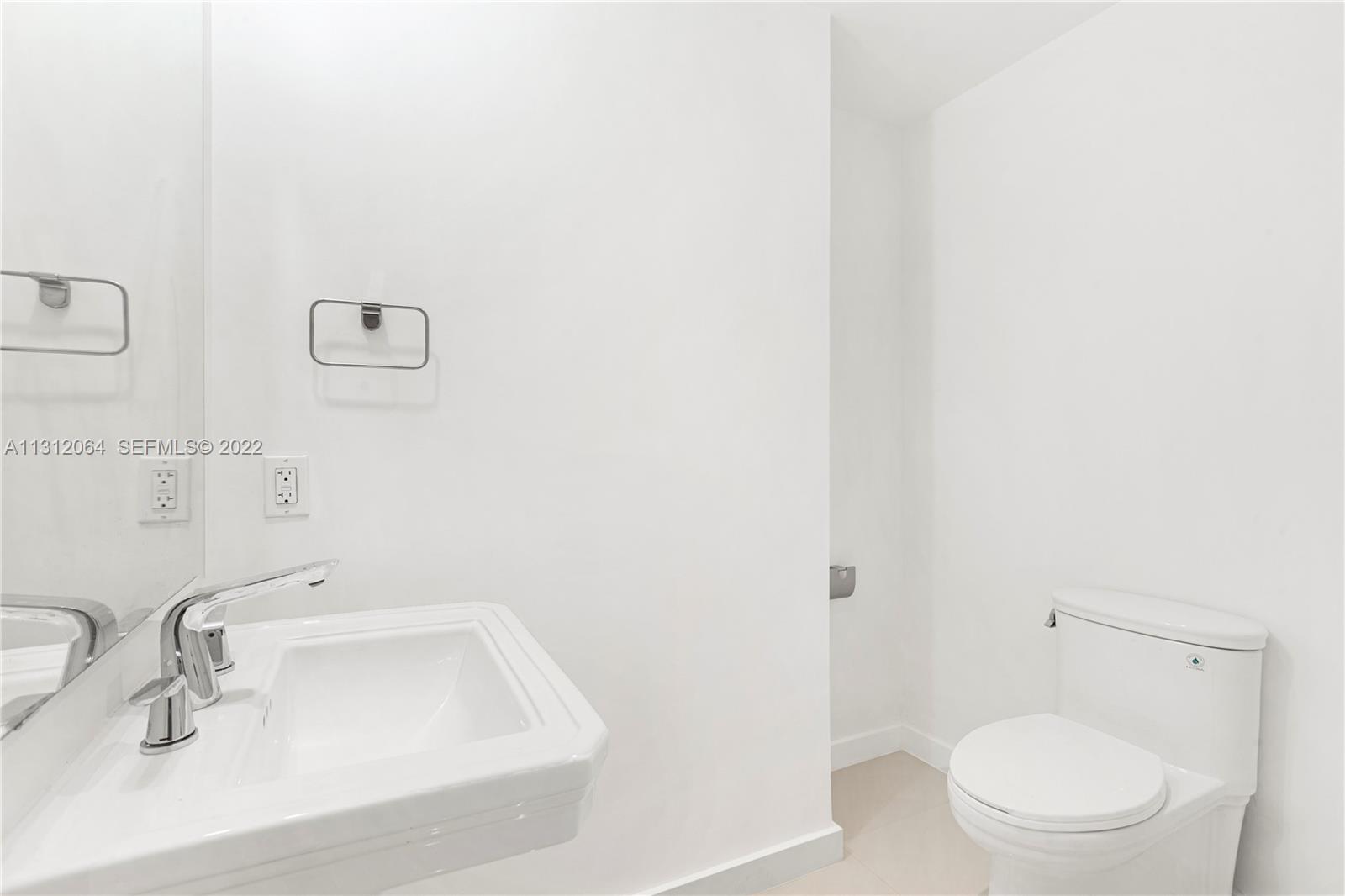 1010 Southwest 2nd Avenue, Unit 2004 Miami, FL 33130 - Photo 14 of 19 a bathroom with a sink a toilet and shower