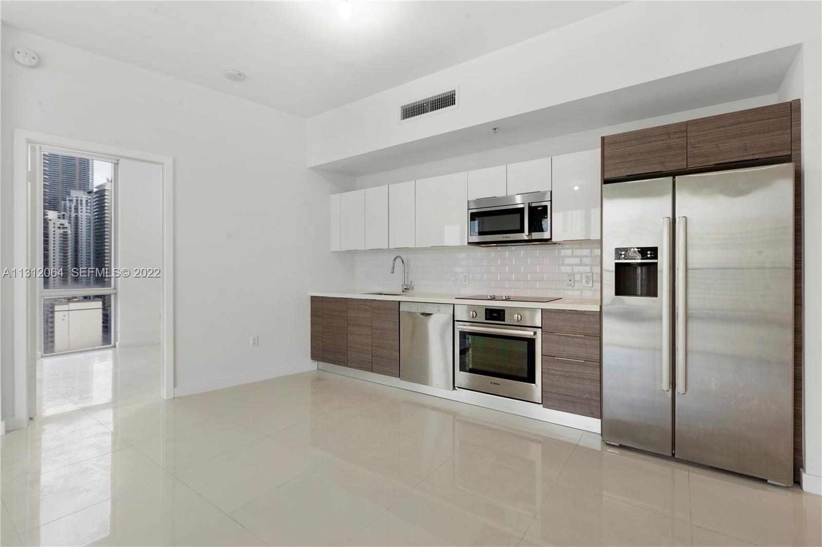 1010 Southwest 2nd Avenue, Unit 2004 Miami, FL 33130 - Photo 3 of 19 a kitchen with a refrigerator and a stove