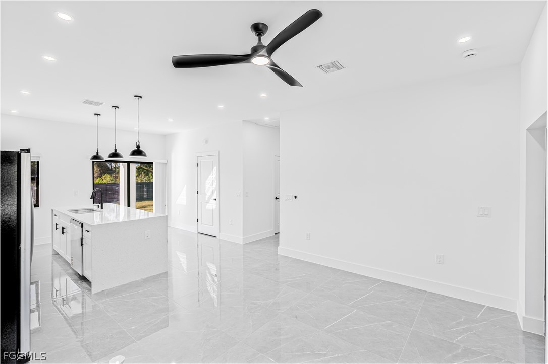 745 Roma Avenue South Lehigh Acres, FL 33974 - Photo 11 of 40 wooden floor in an empty room with a window