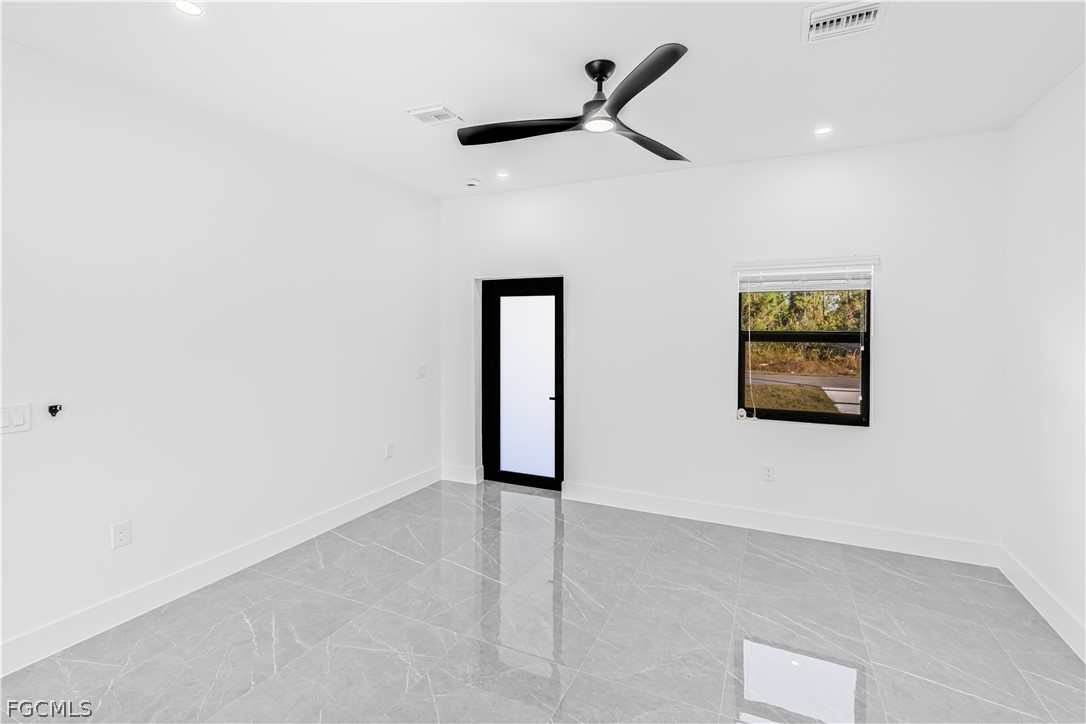 745 Roma Avenue South Lehigh Acres, FL 33974 - Photo 12 of 40 an empty room with a ceiling fan and window