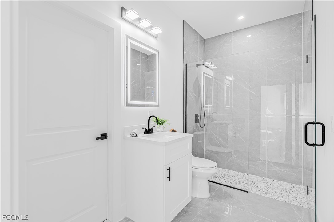 745 Roma Avenue South Lehigh Acres, FL 33974 - Photo 19 of 40 a bathroom with a sink a toilet and shower