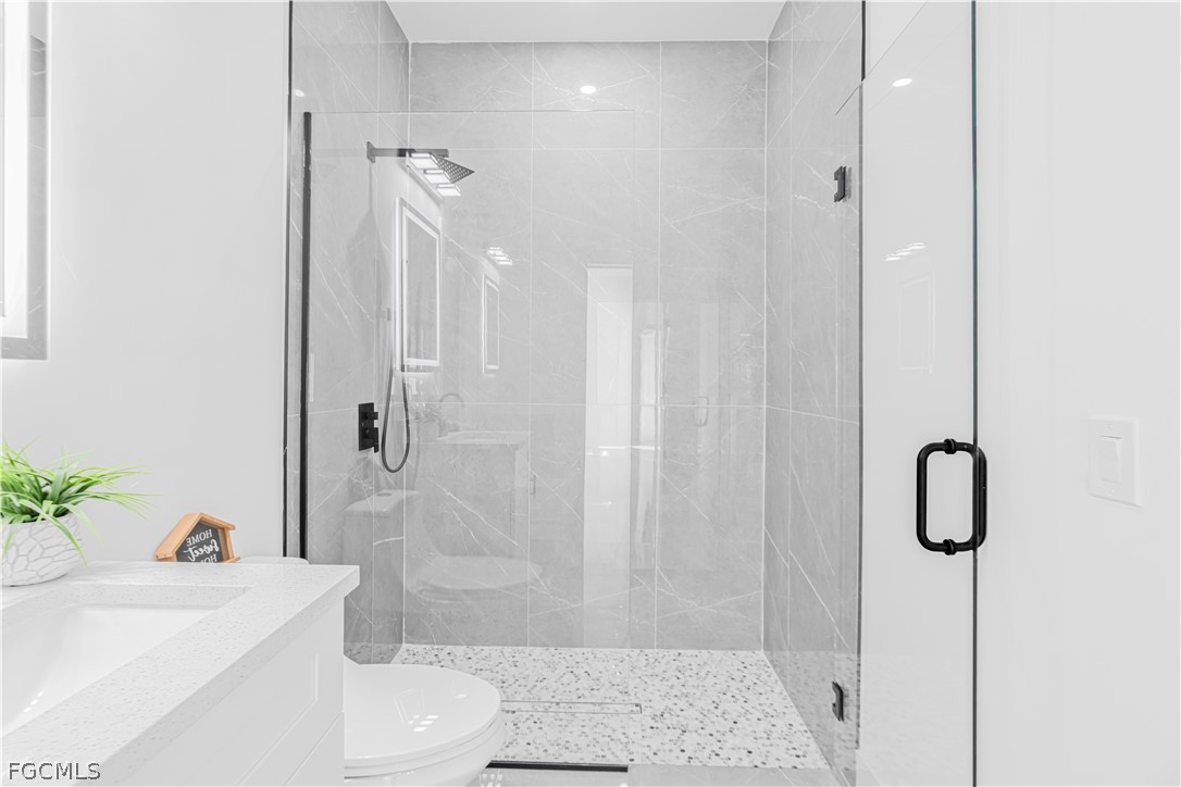 745 Roma Avenue South Lehigh Acres, FL 33974 - Photo 20 of 40 a bathroom with a sink a toilet and shower