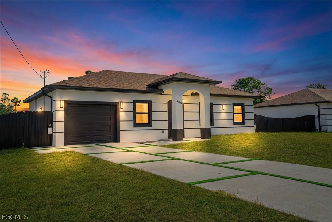 745 Roma Avenue South Lehigh Acres, FL 33974 - Photo 2 of 40 a front view of a house with a garden