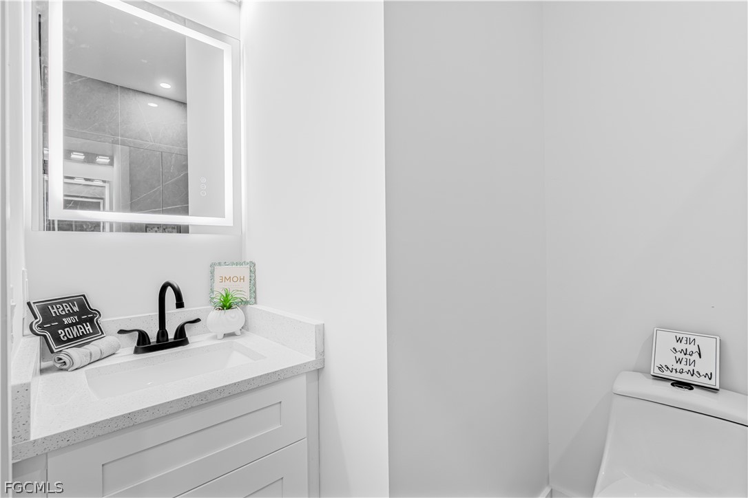 745 Roma Avenue South Lehigh Acres, FL 33974 - Photo 25 of 40 a bathroom with a sink and a mirror