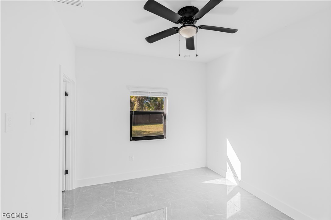 745 Roma Avenue South Lehigh Acres, FL 33974 - Photo 30 of 40 an empty room with a window and a fan