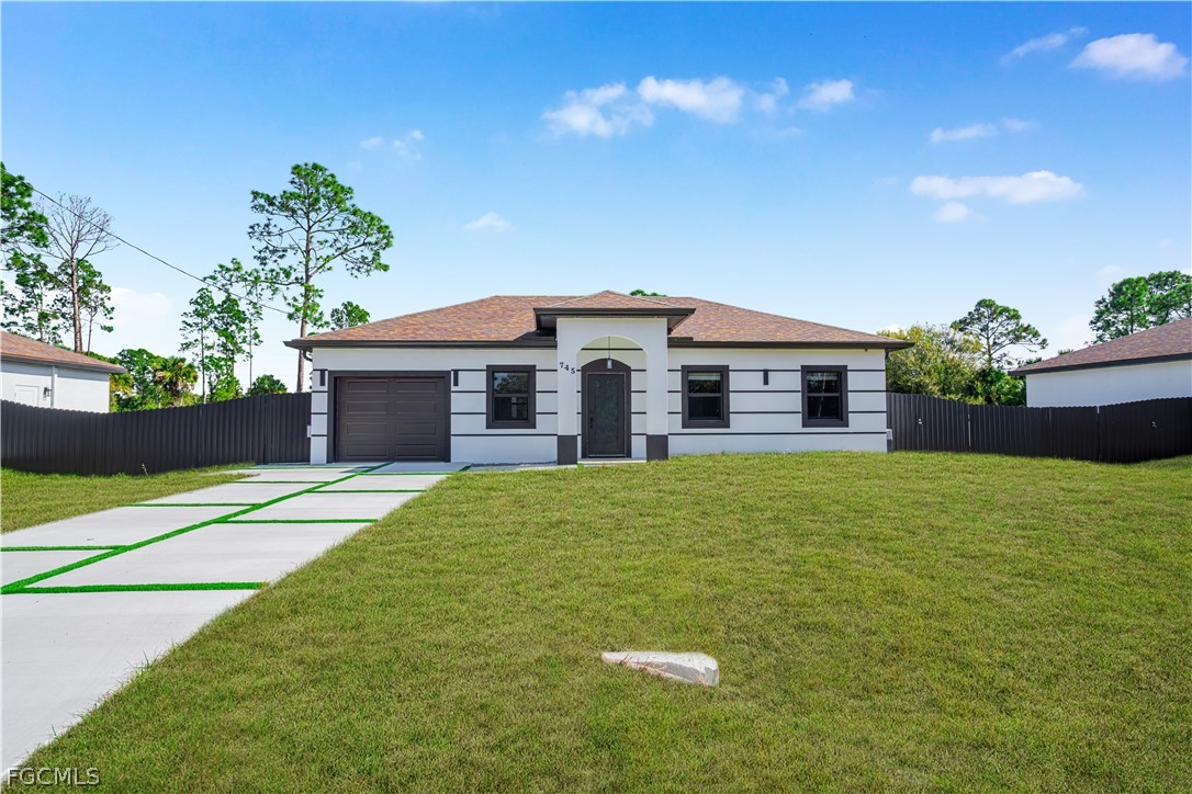 745 Roma Avenue South Lehigh Acres, FL 33974 - Photo 3 of 40 a house view with a garden space