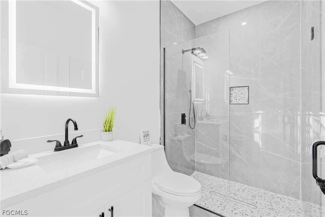 745 Roma Avenue South Lehigh Acres, FL 33974 - Photo 32 of 40 a bathroom with a sink a toilet and shower
