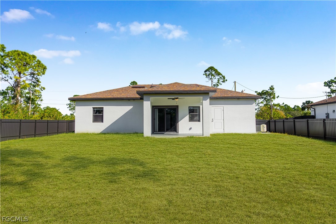 745 Roma Avenue South Lehigh Acres, FL 33974 - Photo 36 of 40 a view of a house with a yard and potted plants