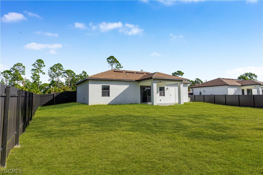 745 Roma Avenue South Lehigh Acres, FL 33974 - Photo 38 of 40 a house with green field in front of it