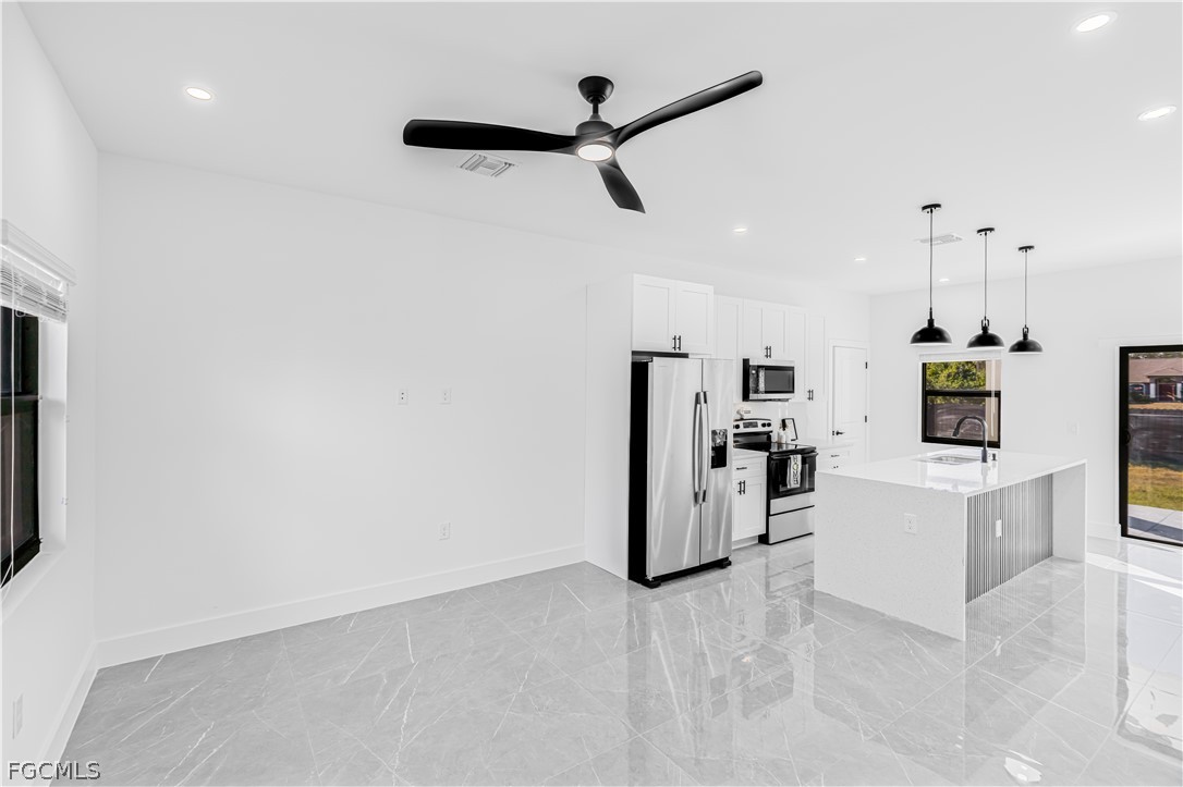 745 Roma Avenue South Lehigh Acres, FL 33974 - Photo 10 of 40 a view of kitchen with stainless steel appliances refrigerator stove microwave and stove