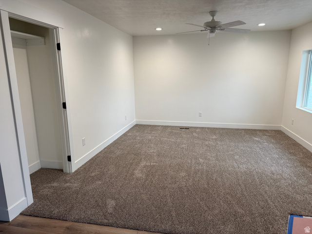 2865 North 3250 W Road Sutherland, UT 84624 - Photo 7 of 28 Carpeted room featuring a ceiling fan with integrated lighting, recessed lighting, and a window