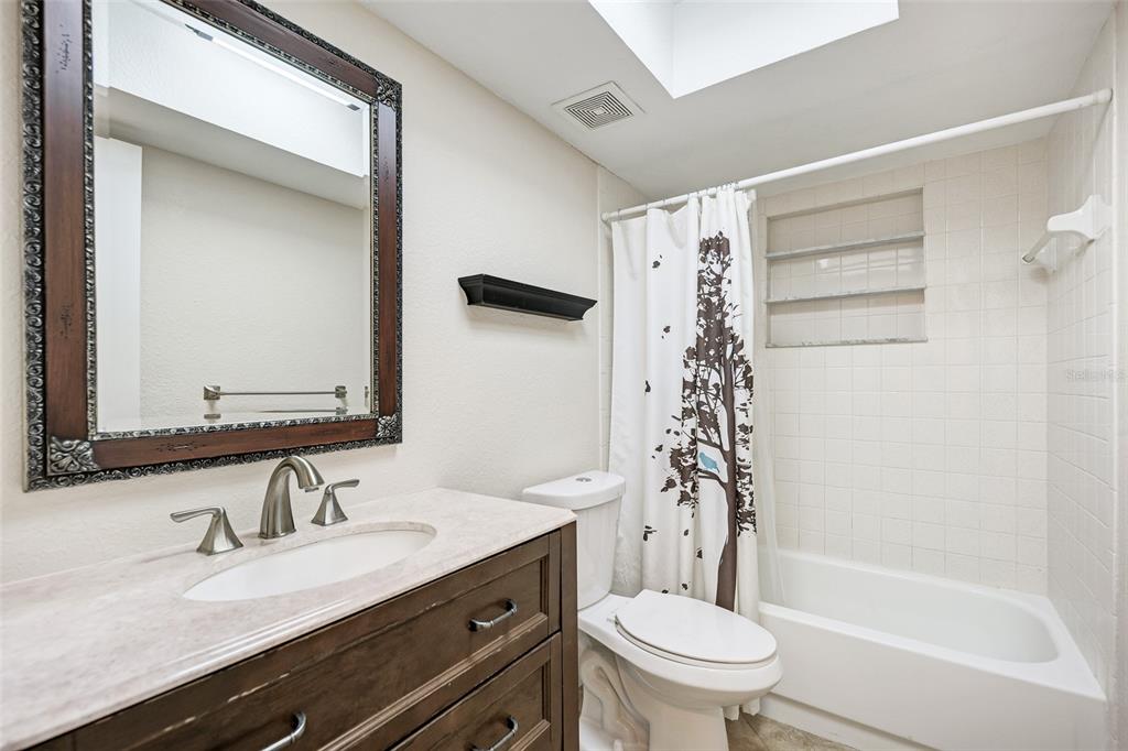 1330 Georgetowne Circle Sarasota, FL 34232 - Photo 33 of 46 a bathroom with a sink a toilet and shower
