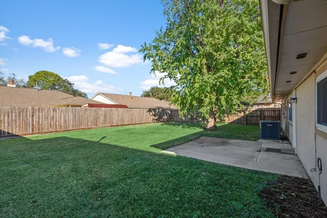 a view of a backyard with a tree