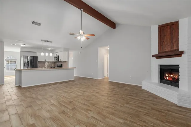a view of a kitchen with a sink and a fireplace