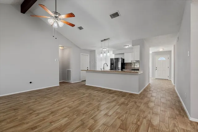 a view of kitchen and hall with wooden floor